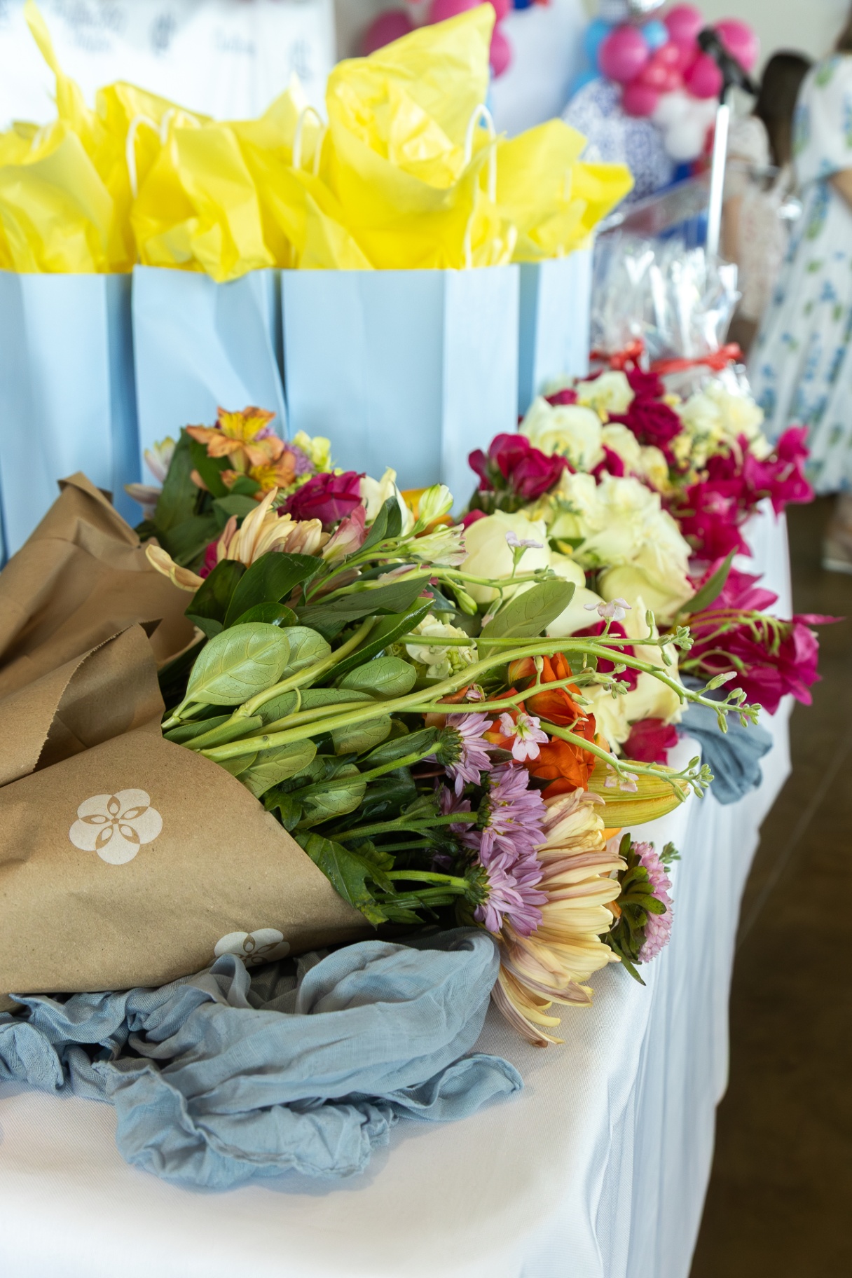 Colorful floral bouquets wrapped in paper ready for a celebration.
