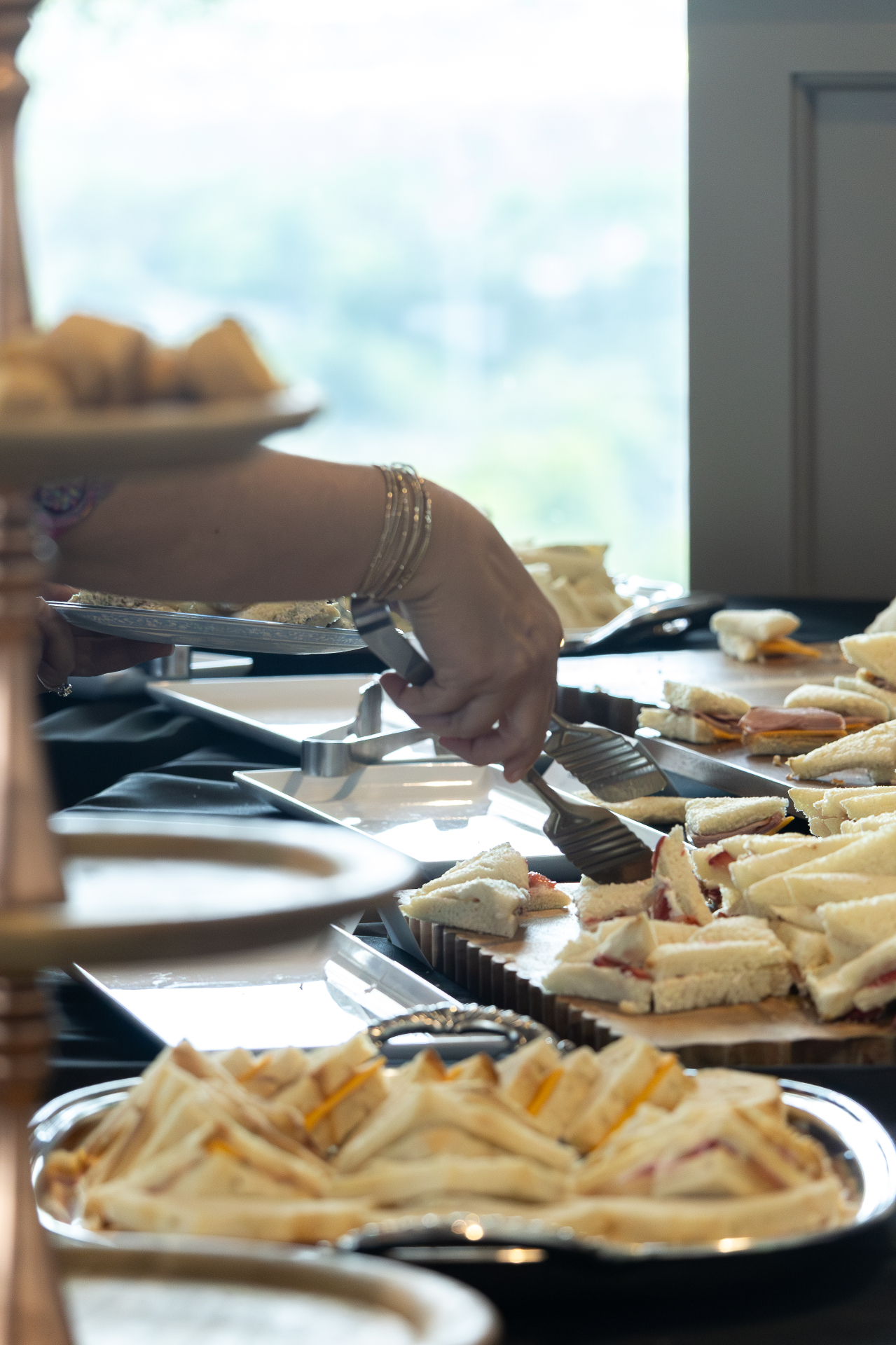 Guest serving themselves from a catering spread.